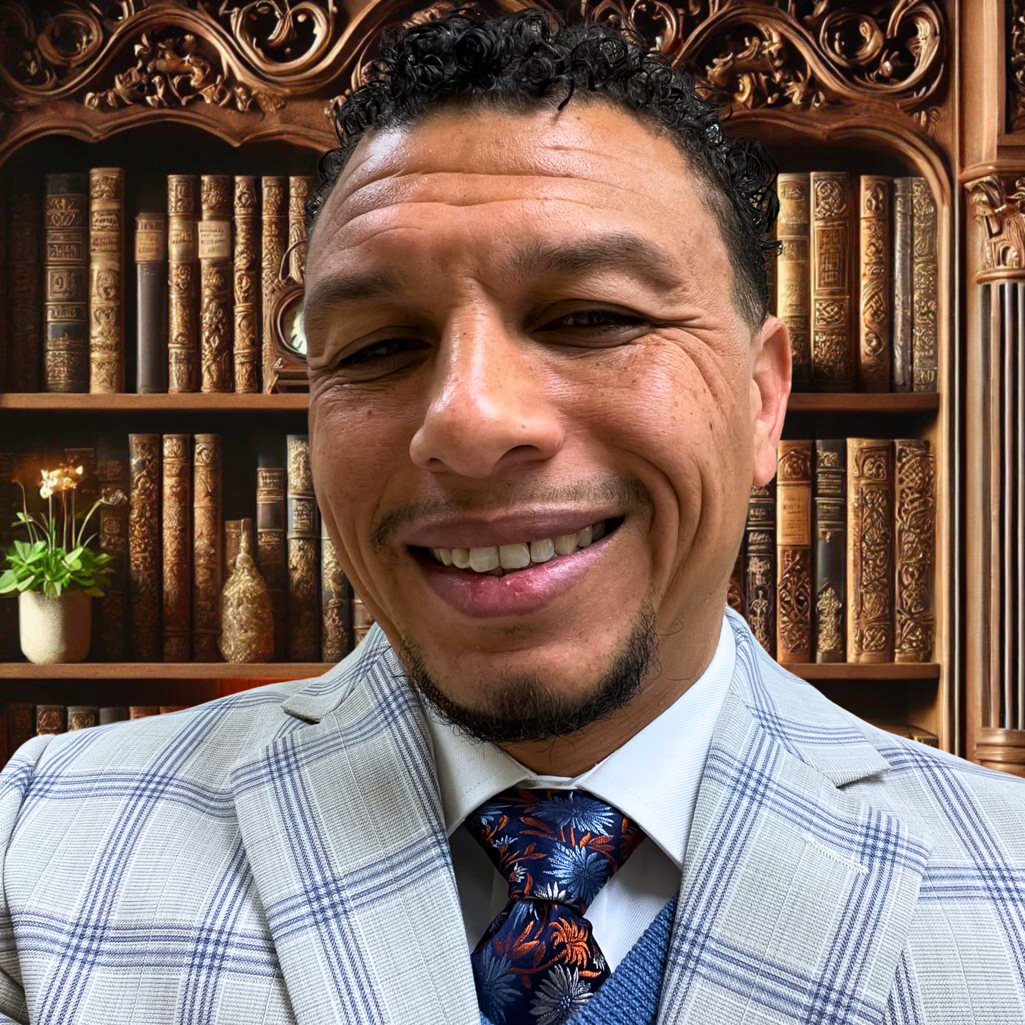 A photo of Jeremiah Van Wagner standing in front of a bookcase.